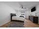 Serene bedroom with hardwood floors, a ceiling fan, a television, and a large window at 10092 Lee St, Broomfield, CO 80021