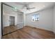 Bright bedroom with hardwood floors, mirrored closet, ceiling fan and a sunlit window at 10092 Lee St, Broomfield, CO 80021