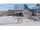 Inviting home showcasing a large front yard and attached two-car garage on a sunny winter day at 10092 Lee St, Broomfield, CO 80021