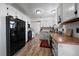 Well-lit kitchen featuring white cabinets, butcher block countertops, and modern black appliances at 10092 Lee St, Broomfield, CO 80021