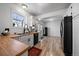 Well-lit kitchen featuring butcher block countertops, white cabinetry, and modern black appliances at 10092 Lee St, Broomfield, CO 80021