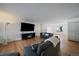 Spacious living room featuring hardwood floors, comfortable seating, and a modern fireplace at 10092 Lee St, Broomfield, CO 80021