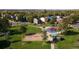 Aerial view of community playground with swings and play equipment, nestled among trees at 10676 Forester Pl, Longmont, CO 80504
