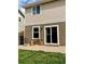 A backyard with grass, a paver patio, and chairs for outdoor relaxation at 10676 Forester Pl, Longmont, CO 80504