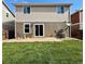 Backyard with a well-maintained lawn, patio area, and house exterior at 10676 Forester Pl, Longmont, CO 80504