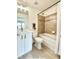 Primary bathroom with a tub-shower, white cabinets, modern fixtures and a stylish vanity with a quartz countertop at 10676 Forester Pl, Longmont, CO 80504