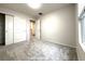Well-lit bedroom featuring carpet flooring, neutral walls, closet with double doors, and large window at 10676 Forester Pl, Longmont, CO 80504