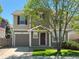 Charming two-story home with a well-maintained lawn and a tree-lined street at 10676 Forester Pl, Longmont, CO 80504