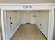Spacious garage with tiled flooring, an outlet for charging, and a door leading into the house at 10676 Forester Pl, Longmont, CO 80504