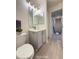 Hall bathroom with gray vanity, modern fixtures, and tile flooring at 10676 Forester Pl, Longmont, CO 80504