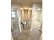 Bright hallway with carpeted floor, leading to the staircase and multiple bedrooms at 10676 Forester Pl, Longmont, CO 80504