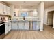 Well-lit kitchen with stone backsplash, stainless steel appliances, and hardwood flooring at 10676 Forester Pl, Longmont, CO 80504