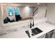Open concept kitchen with stainless steel sink, modern fixtures, and natural light at 10676 Forester Pl, Longmont, CO 80504