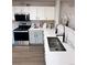 Bright kitchen featuring stainless steel appliances, white cabinets, and quartz countertops with stylish hardware at 10676 Forester Pl, Longmont, CO 80504