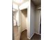 Open closet leading to the laundry room with white washer and dryer at 10676 Forester Pl, Longmont, CO 80504