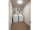 Convenient laundry room featuring modern washer and dryer, wire shelving, and ample space for laundry essentials at 10676 Forester Pl, Longmont, CO 80504