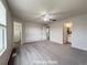Spacious primary suite with plush carpeting, a ceiling fan, and ensuite bathroom, offering a serene retreat at 10676 Forester Pl, Longmont, CO 80504