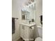 Primary bathroom features a white vanity with modern fixtures and tile flooring at 10676 Forester Pl, Longmont, CO 80504