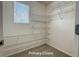 Walk-in primary closet featuring wire shelving and a window, maximizing storage and organization at 10676 Forester Pl, Longmont, CO 80504