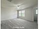 Spacious primary suite with carpet flooring, ceiling fan, and natural light at 10676 Forester Pl, Longmont, CO 80504