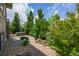 Private backyard patio with hot tub, fire pit, and lush greenery at 198 Starlight Cir, Erie, CO 80516