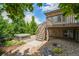 Landscaped backyard with hot tub, deck, and mature trees, creating a private oasis at 198 Starlight Cir, Erie, CO 80516