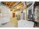 Unfinished basement with utilities, laundry area, and storage space ready for customization at 198 Starlight Cir, Erie, CO 80516