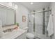 Bathroom featuring white subway tile shower with glass door, modern vanity, and stylish mosaic accents at 198 Starlight Cir, Erie, CO 80516