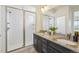 Bathroom featuring double vanity, granite countertop, stylish tile, and a glass-enclosed shower at 198 Starlight Cir, Erie, CO 80516