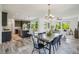 Open-concept dining area featuring a stylish light fixture and seamless flow into the modern kitchen at 198 Starlight Cir, Erie, CO 80516