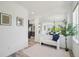 Bright entryway featuring white walls, wood floors, and an open view of the kitchen and dining area at 198 Starlight Cir, Erie, CO 80516