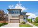 Inviting two-story home featuring a stone facade, a two-car garage, and landscaped front yard at 198 Starlight Cir, Erie, CO 80516