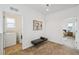Hallway nook with bench leading to laundry room and carpeted bedroom at 198 Starlight Cir, Erie, CO 80516