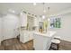 Stylish kitchen with white cabinetry, quartz countertops, stainless steel appliances, and island with seating at 198 Starlight Cir, Erie, CO 80516