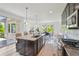 Bright kitchen boasts a granite island, stainless steel appliances, and sliding door access to the outdoor patio at 198 Starlight Cir, Erie, CO 80516