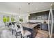 Bright, modern kitchen with a large island, sleek appliances, and open views of the dining area at 198 Starlight Cir, Erie, CO 80516