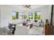 Inviting living room with large windows, neutral decor, and comfortable seating arrangement at 198 Starlight Cir, Erie, CO 80516