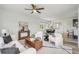 Cozy living room with a modern ceiling fan, white walls, and a view into the dining area at 198 Starlight Cir, Erie, CO 80516