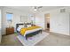 Bright and airy main bedroom with large windows, ensuite bathroom, and stylish gray and yellow decor at 198 Starlight Cir, Erie, CO 80516