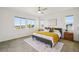 Sunny main bedroom featuring plush carpet, multiple bright windows, and modern decor at 198 Starlight Cir, Erie, CO 80516
