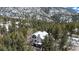 Aerial view of a beautiful home nestled among tall trees, showcasing its scenic surroundings at 846 Circle K Ranch Rd, Evergreen, CO 80439