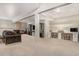 Open basement featuring comfortable seating, a TV area, and a dedicated workspace at 846 Circle K Ranch Rd, Evergreen, CO 80439