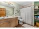 Charming bathroom with a wood vanity, matching wood door, and a shower/tub combination at 846 Circle K Ranch Rd, Evergreen, CO 80439