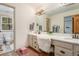 Bathroom featuring dual sinks, a large mirror, and access to the toilet and shower at 846 Circle K Ranch Rd, Evergreen, CO 80439