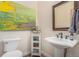 Cozy bathroom with pedestal sink, decorative mirror, and modern fixtures at 846 Circle K Ranch Rd, Evergreen, CO 80439