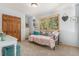 Cozy bedroom with a daybed, natural light, and closet at 846 Circle K Ranch Rd, Evergreen, CO 80439