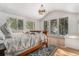Bright bedroom with natural light, hardwood floors, and forest views from multiple large windows at 846 Circle K Ranch Rd, Evergreen, CO 80439