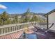 Relaxing deck with a hammock, seating and stunning views of snow-capped mountains and a dense forest at 846 Circle K Ranch Rd, Evergreen, CO 80439