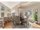 Elegant dining room boasts a round table with seating, a stone accent wall, and bright natural light at 846 Circle K Ranch Rd, Evergreen, CO 80439