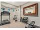 Home gym featuring a treadmill, bike, free weights, and a large decorative mirror at 846 Circle K Ranch Rd, Evergreen, CO 80439